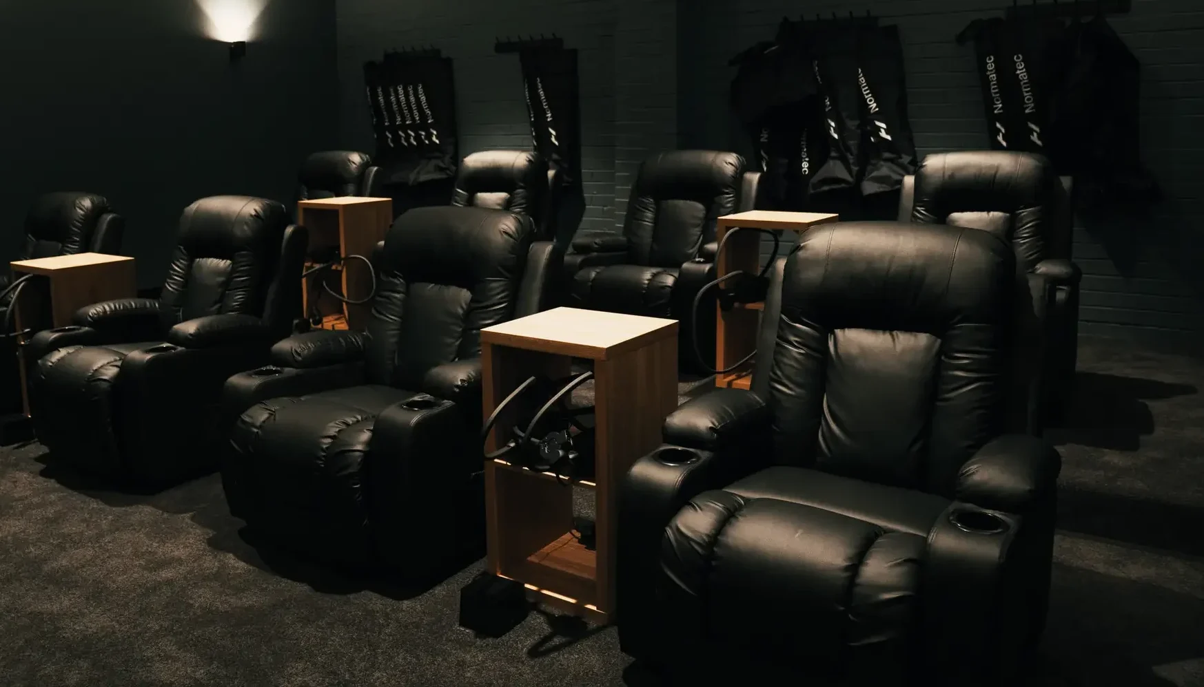 Rows of lux massage recliners in the P3 Recovery Performance compression lounge.